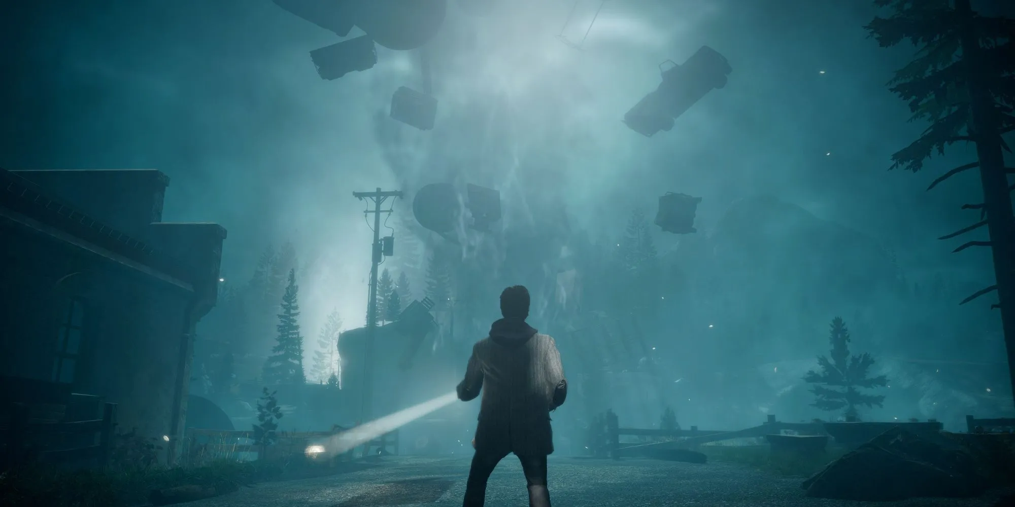 Alan Wake đứng với ngọn đuốc trong môi trường siêu nhiên.