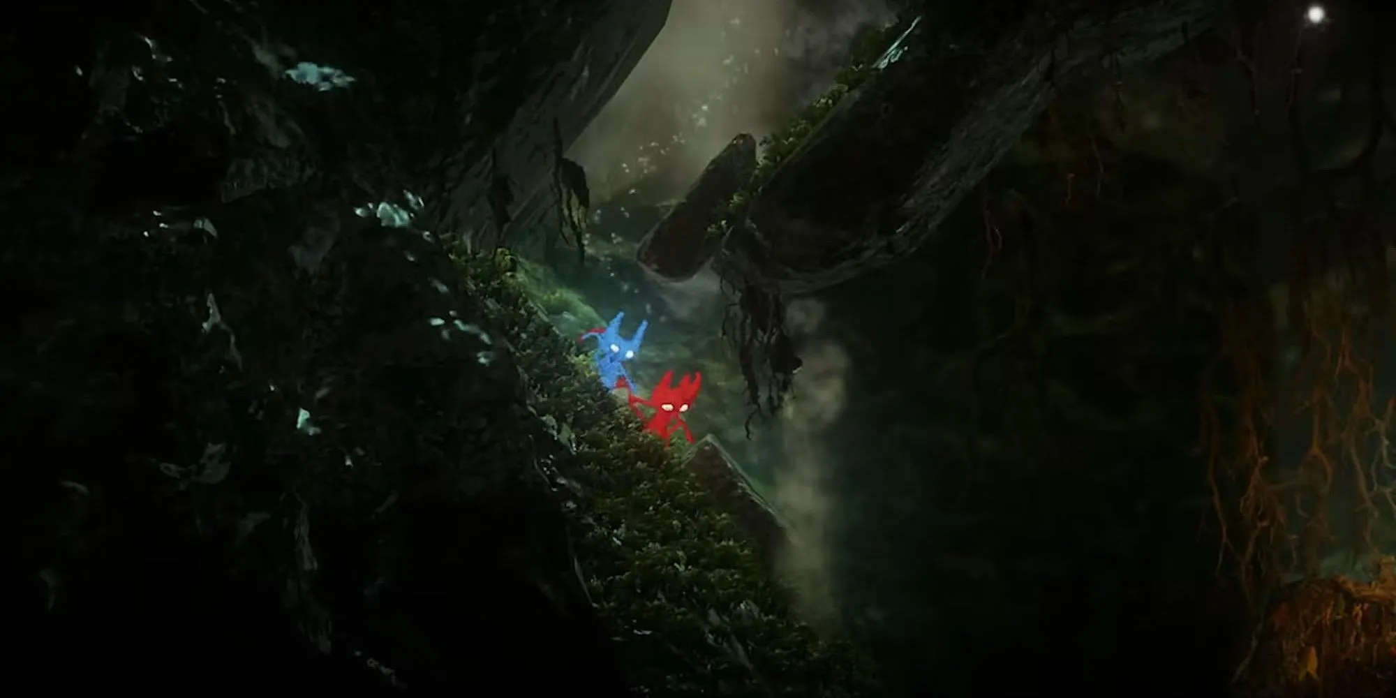 Hai Yarny (nhân vật sợi len) leo xuống vách đá trong game Unravel Two