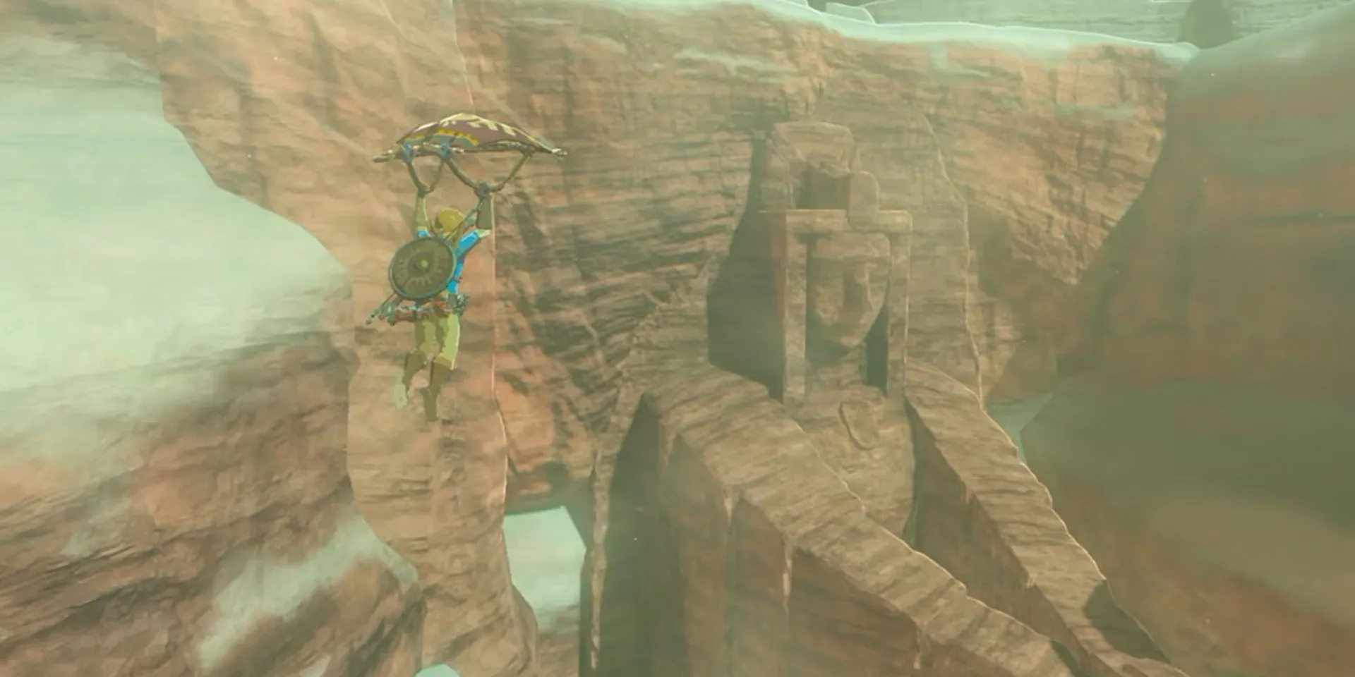 Link Paraglides towards ruins in The Legend of Zelda: Breath of the Wild