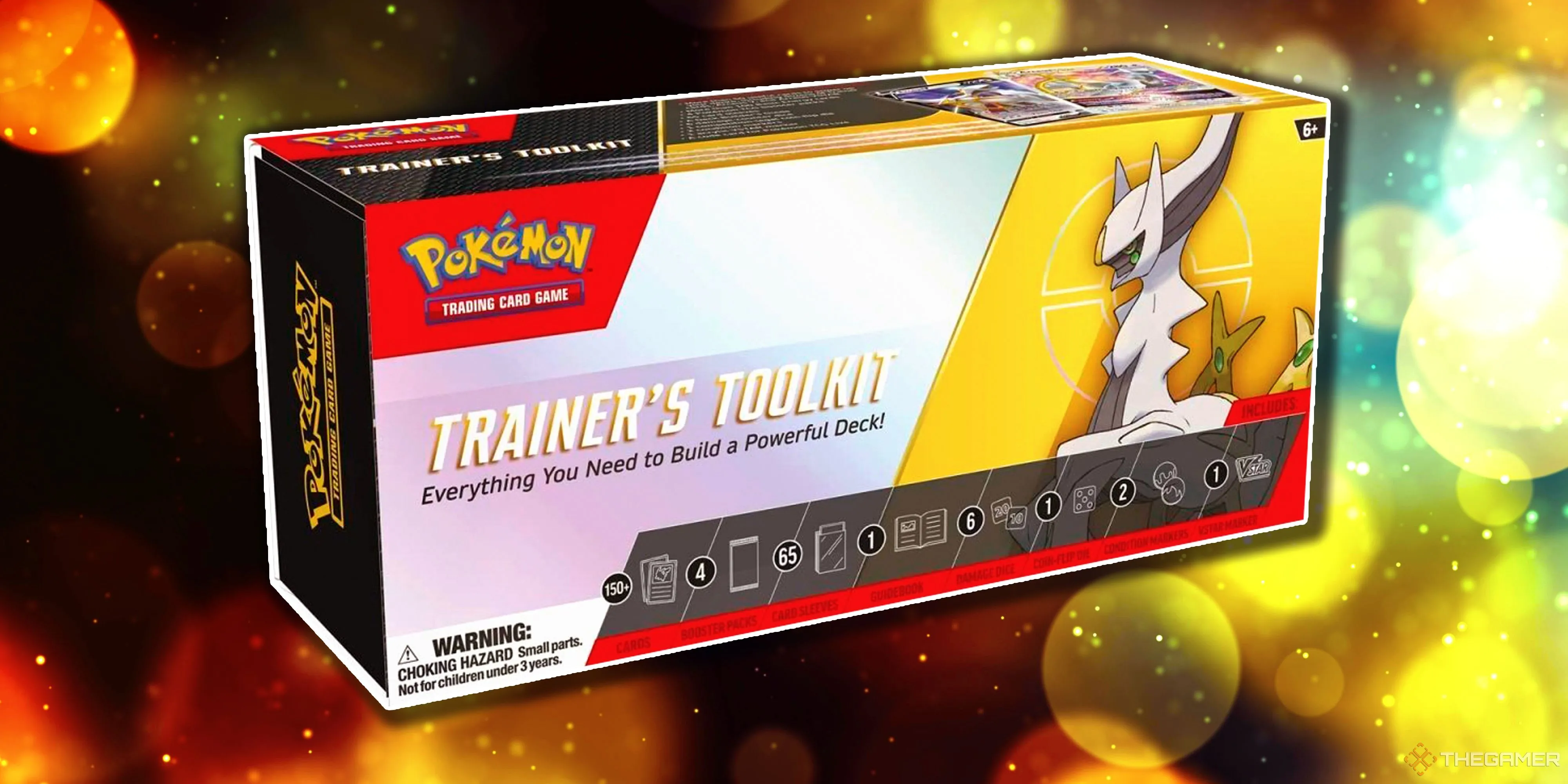 Hộp Pokemon TCG Trainer’s Toolkit 2023 màu trắng tím, nổi bật với hình ảnh Arceus, bên trong là các gói booster và thẻ bài chiến lược.